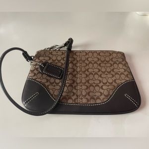 Coach Corner Zip Wristlet In Signature Canvas. Color Light/Dark Brown Leather.